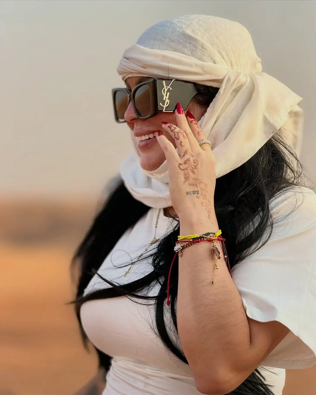 Guest in a traditional headscarf in the desert